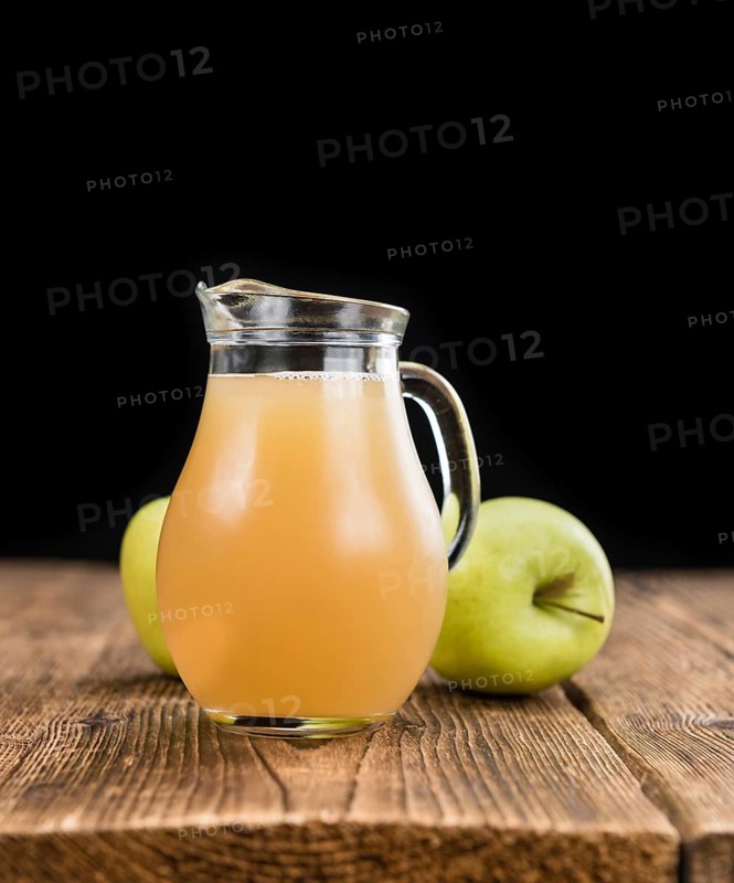 Apple Juice on a vintage background as detailed close-up shot (selective focus)