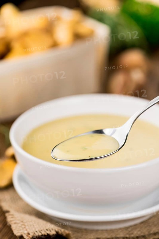 Fresh made Chanterelle Soup on a vintage background as detailed close-up shot