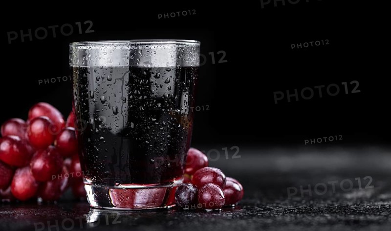 Some fresh Red Grape Juice (selective focus, close-up shot)