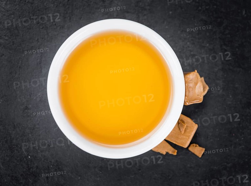 Portion of Caramel Syrup on a rustic slate slab (selective focus, close-up shot)