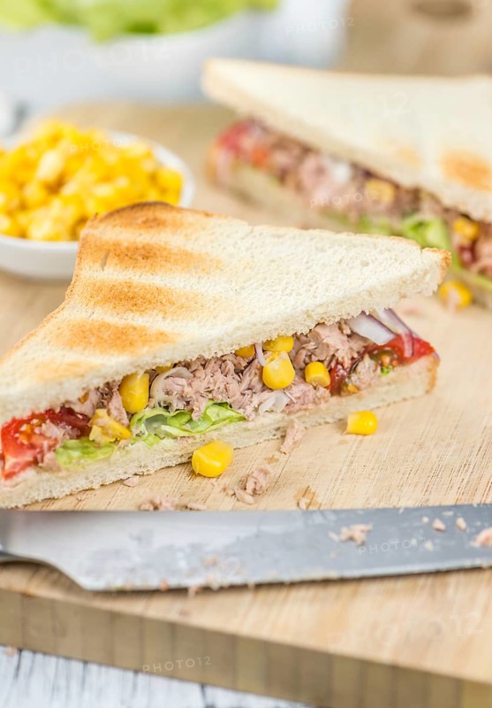 Wooden table with a fresh made Tuna Sandwich (selective focus, close-up shot)