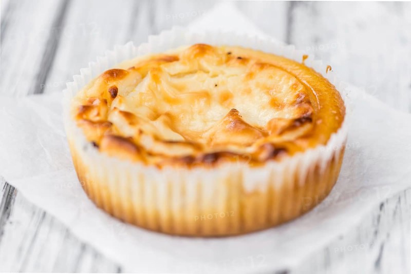 Fresh made Mini Cheesecake on an old and rustic wooden table (selective focus, close-up shot)