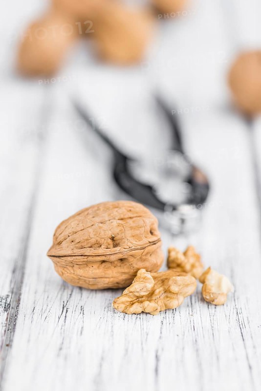 Walnuts on a vintage background as detailed close-up shot (selective focus)