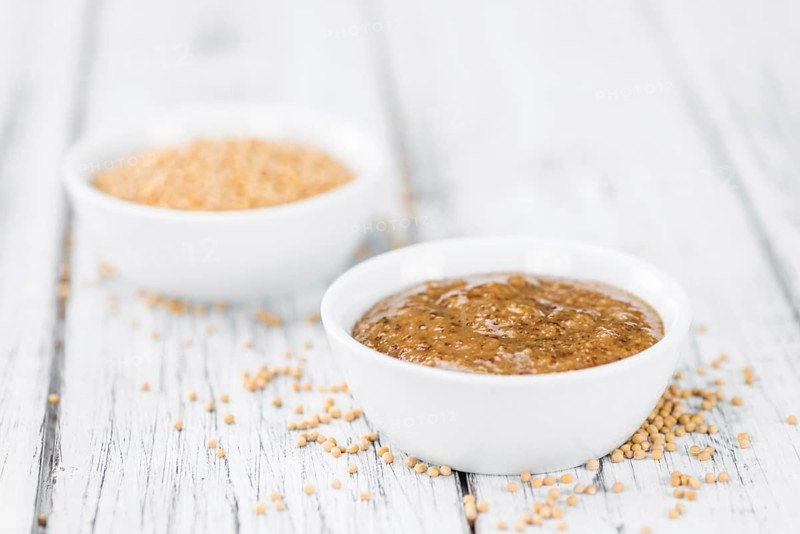 Fresh made German Cuisine (sweet Mustard) on a vintage background (close-up shot)