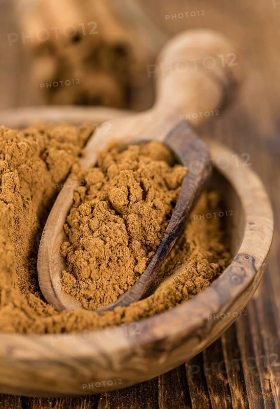 Fresh made Cinnamon Powder on a vintage background (close-up shot)