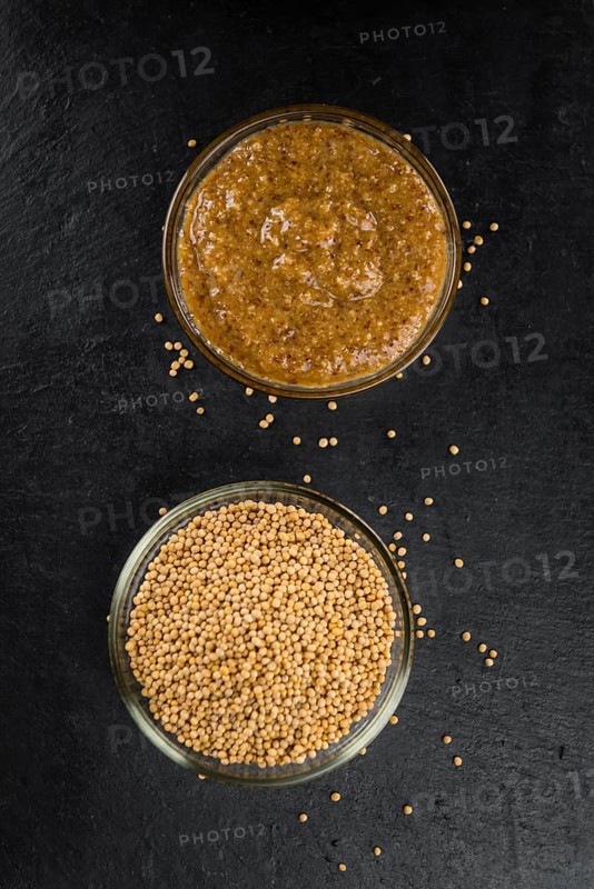 Some German Cuisine (sweet Mustard) on a slate slab (close-up shot, selective focus)