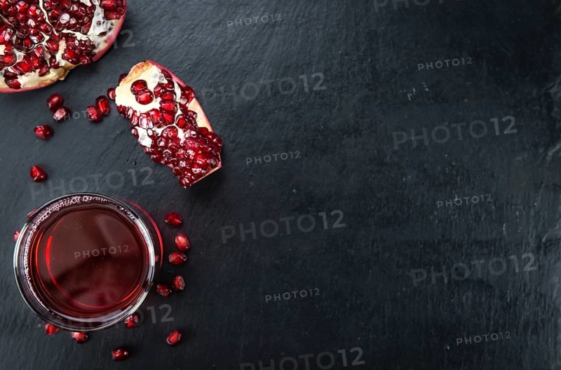 Fresh made Pomegranate juice on a vintage background (close-up shot)