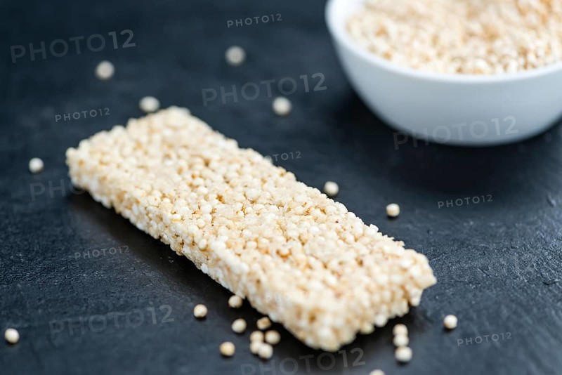 Some Quinoa Bars on a slate slab (close-up shot, selective focus)