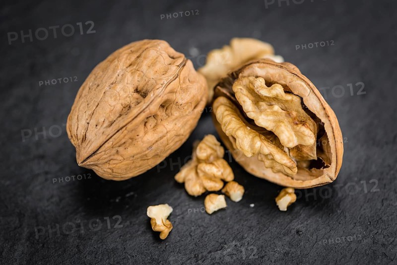 Walnuts on a vintage background as detailed close-up shot (selective focus)
