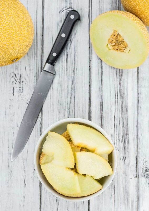 Fresh made Honeydew Melon on a vintage background (close-up shot)