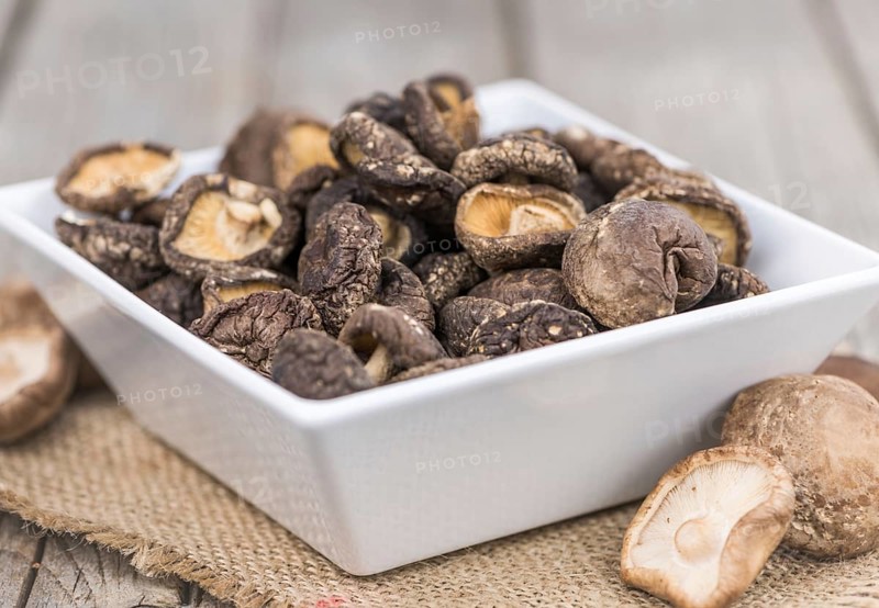 Fresh made Shiitake mushrooms (dried) on an old and rustic wooden table, selective focus, close-up shot