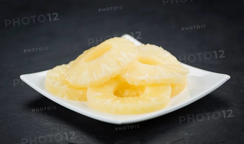 Fresh made Preserved Pineapple Rings on a vintage background as detailed close-up shot