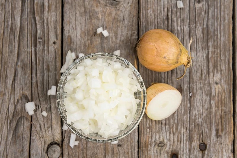 Diced white onions on a vintage background as detailed close-up shot, selective focus
