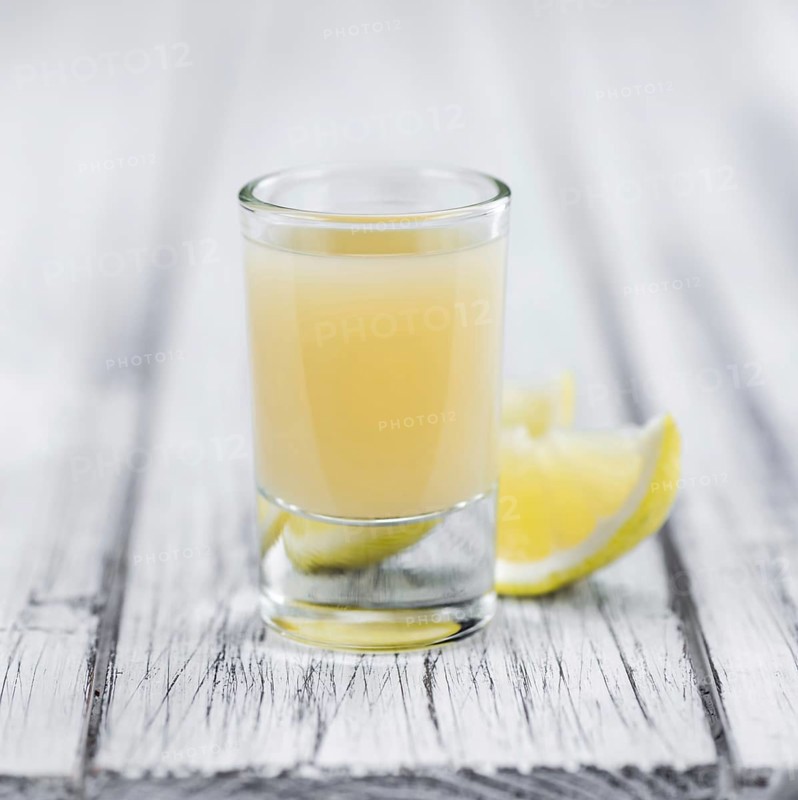 Fresh made Juice (lemon) on a vintage background (close-up shot)