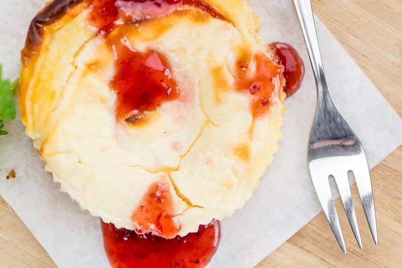 Cheesecake with berry Sacue on a vintage background as detailed close-up shot (selective focus)
