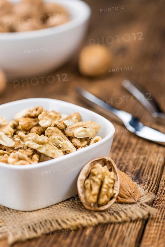 Walnut kernels on a vintage background as detailed close-up shot (selective focus)