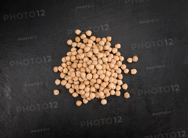 Chickpeas on a vintage background as detailed close-up shot, selective focus