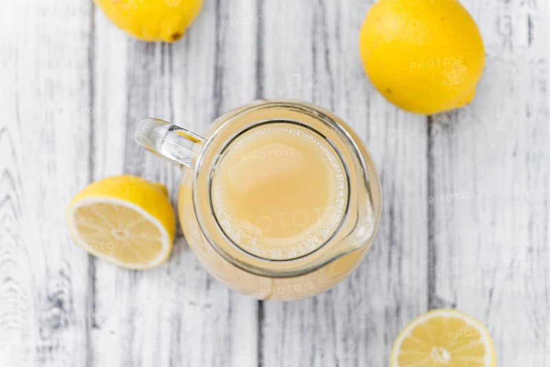 Lemon Juice on a vintage background as detailed close-up shot (selective focus)