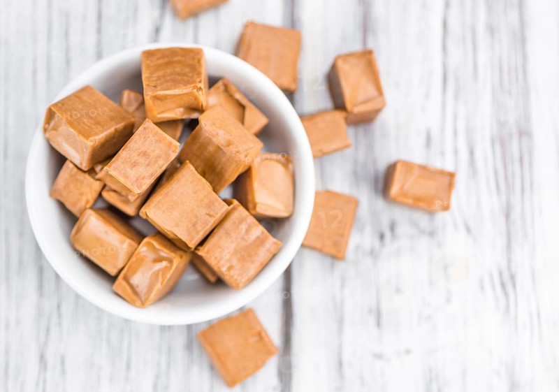 Caramel on a vintage background as detailed close-up shot (selective focus)