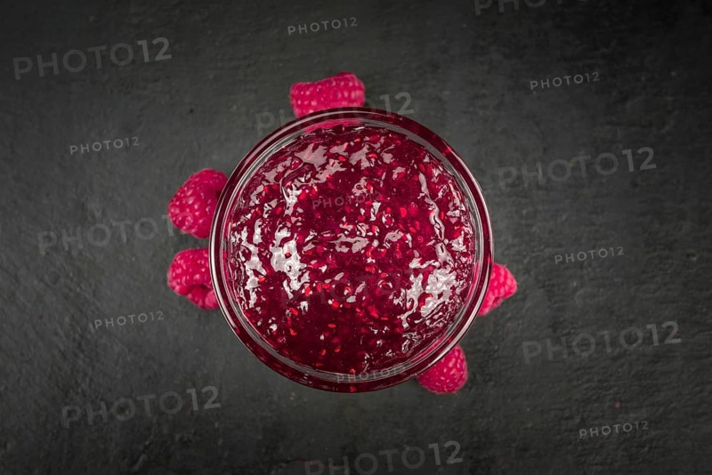 Fresh made Raspberry Jam on a vintage background as detailed close-up shot