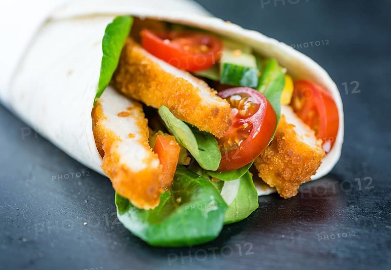 Fresh made Chicken Wraps on an vintage background (selective focus)