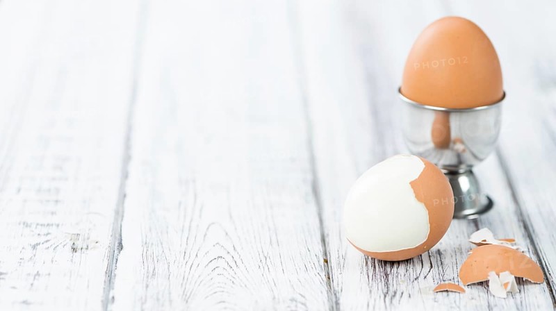 Wooden table with boiled Eggs (selective focus, close-up shot)