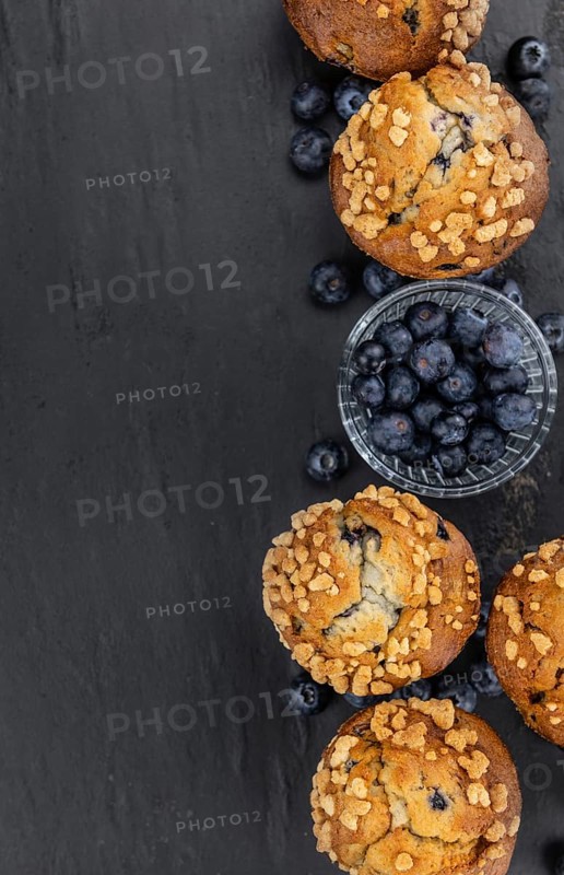Portion of healthy Blueberry Muffins on a slate slab (selective focus)