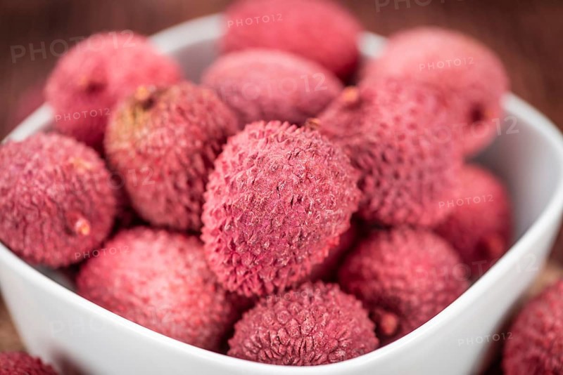 Lychees on a vintage background as detailed close-up shot (selective focus)