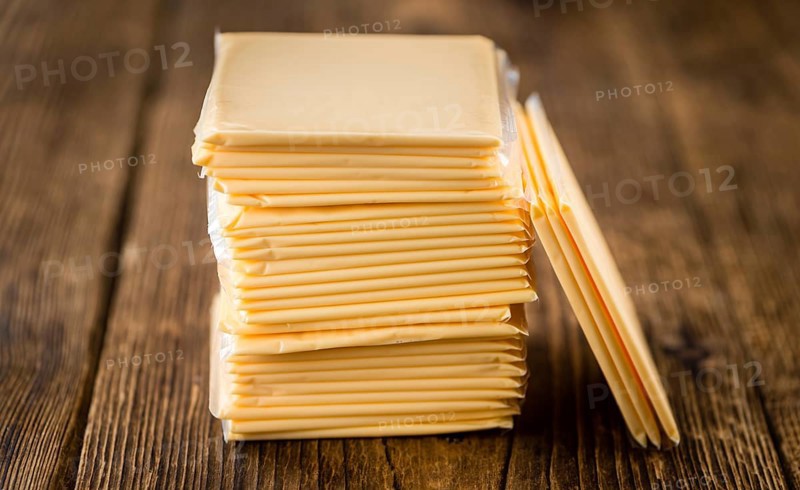 Sliced Cheese on a vintage background as detailed close-up shot (selective focus)