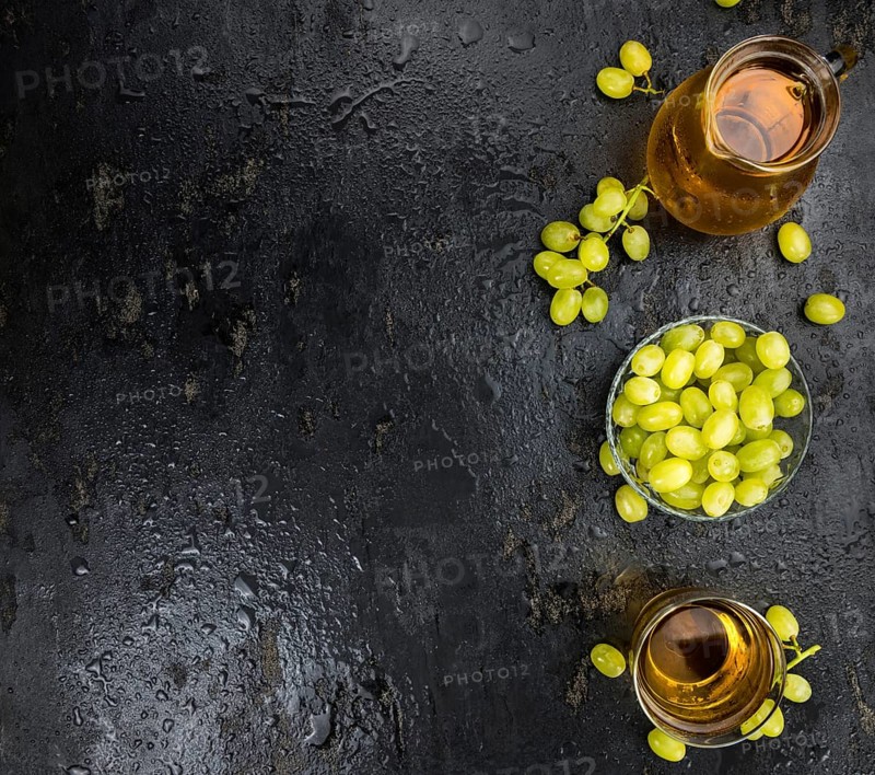 Some healthy Grape Juice on a vintage slate slab (selective focus)