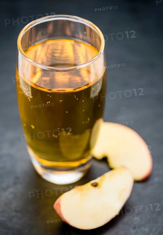 Fresh made Apple Cider on a vintage background (close-up shot)