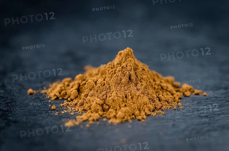 Fresh made Cinnamon Powder on a vintage background (close-up shot)