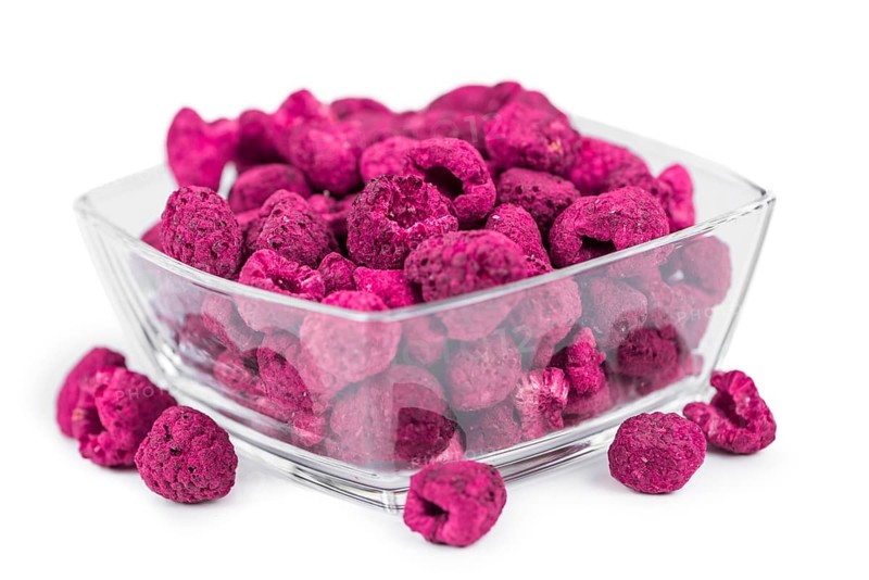 Portion of Dried Raspberries as detailed close-up shot isolated on white background