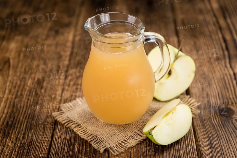 Apple Juice on a vintage background as detailed close-up shot (selective focus)