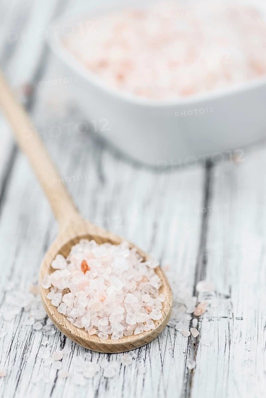 Pink Salt on a vintage background as detailed close-up shot (selective focus)