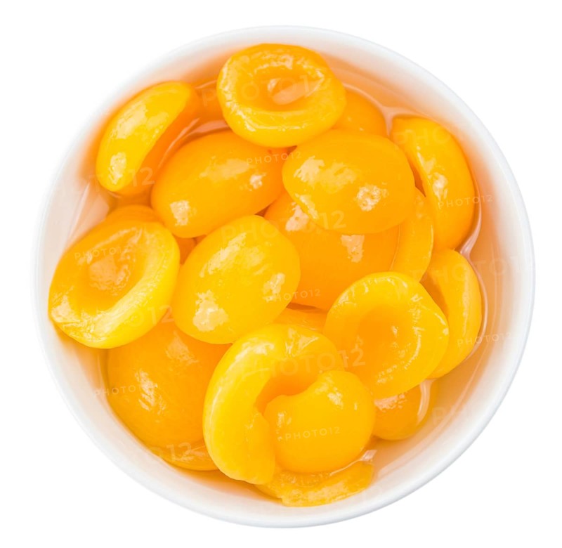 Portion of Pickled Apricots (as close-up shot) isolated on white background