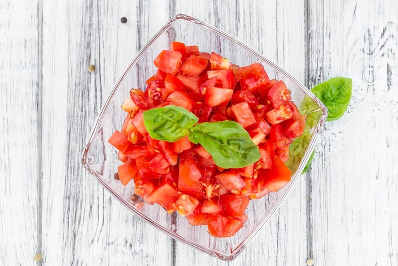 Homemade Cutted Tomatoes on vintage background (selective focus, close-up shot)