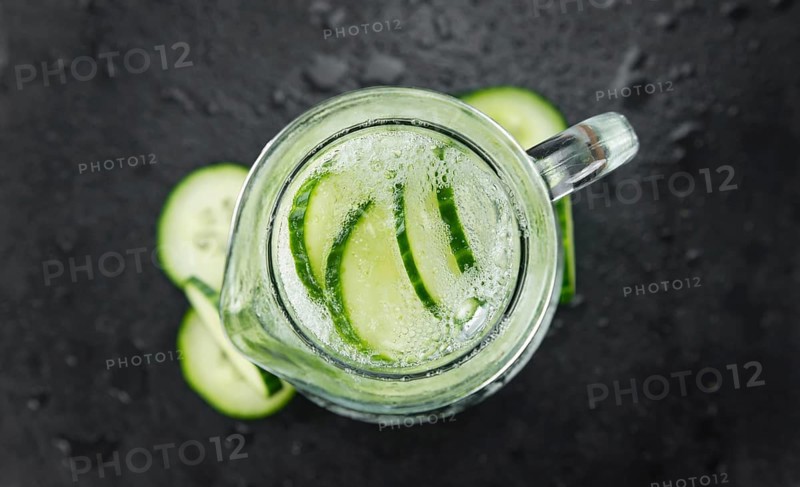 Portion of Cucumber Water as detailed close up shot on a slate slab, selective focus
