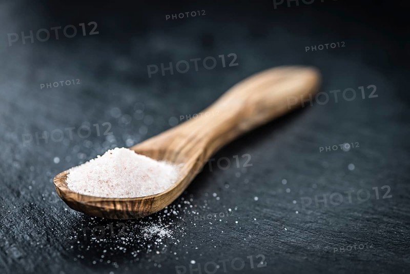 Pink Salt on a vintage background as detailed close-up shot (selective focus)