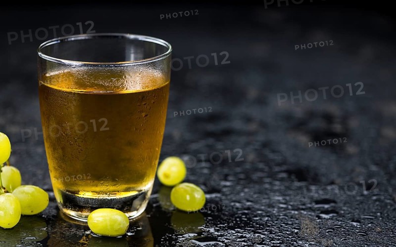 Some healthy Grape Juice on a vintage slate slab (selective focus)