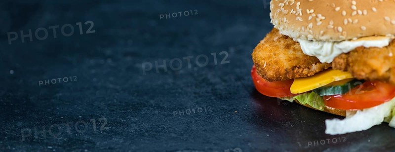 Fish Burger on a slate slab (close-up shot, selective focus)
