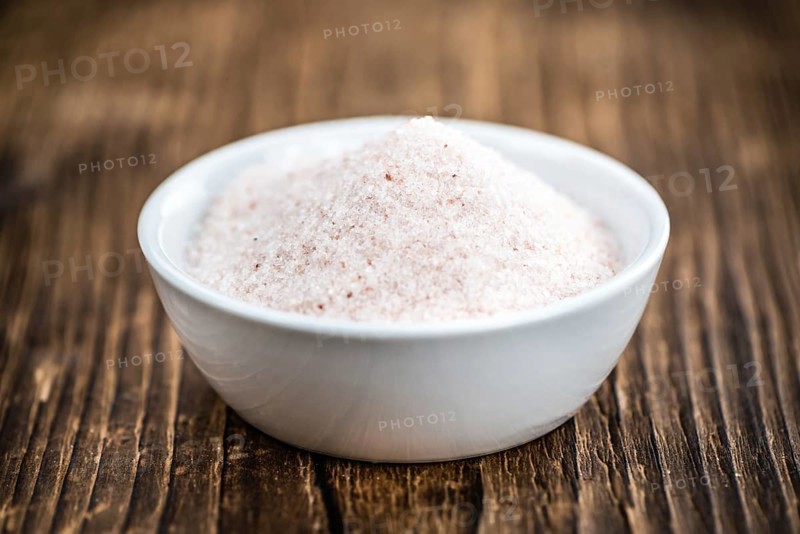 Himalayan Salt as high detailed close-up shot on a vintage wooden table (selective focus)