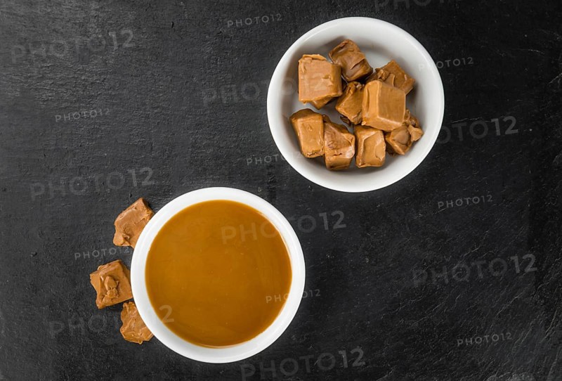 Caramel Sauce on a vintage slate slab (close-up shot, selective focus)