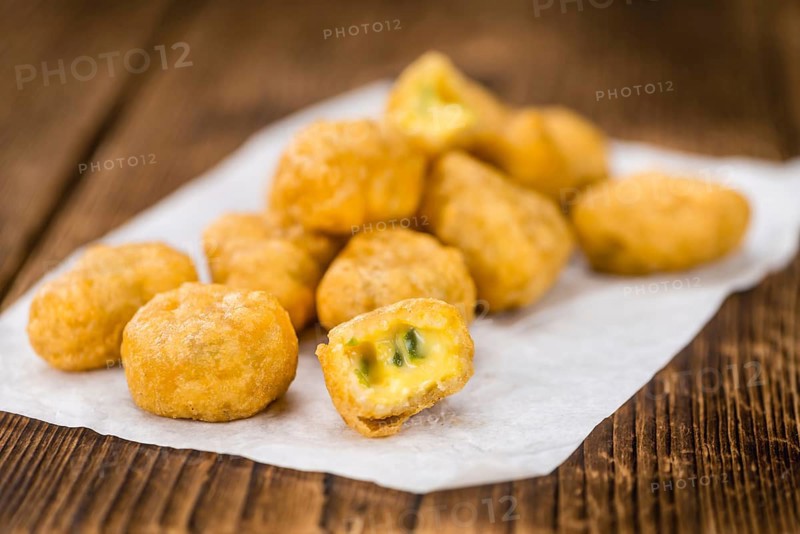 Homemade Cheese Nuggets (with Chilis) on vintage background (selective focus, close-up shot)