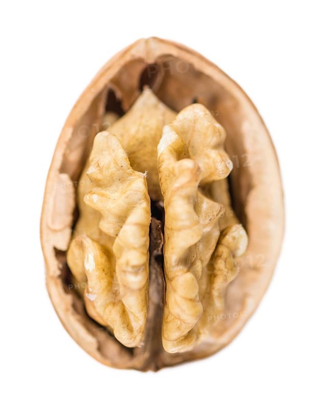 Portion of Walnut kernels (as close-up shot) isolated on white background
