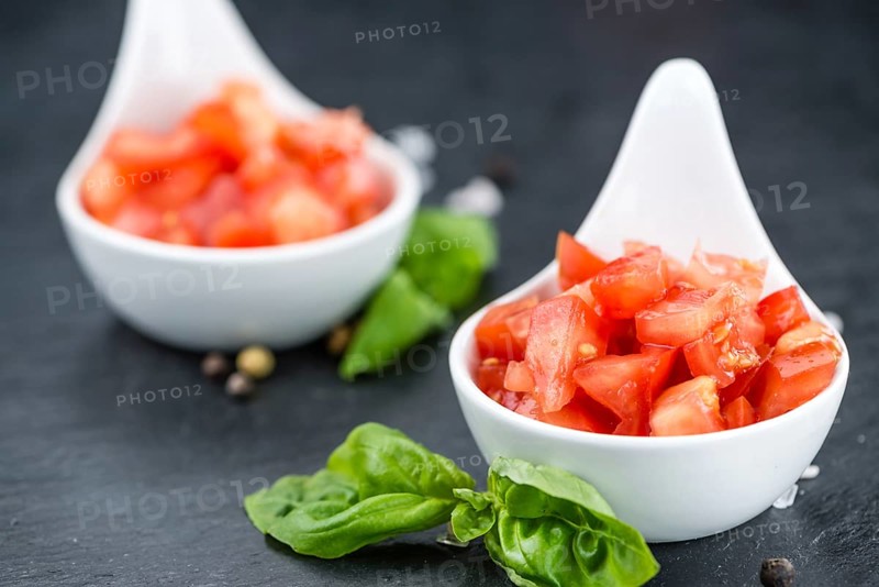 Diced Tomatoes on a vintage background as detailed close-up shot (selective focus)