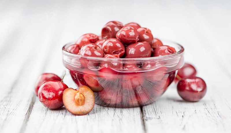Preserved Cherries on a vintage background as detailed close-up shot, selective focus