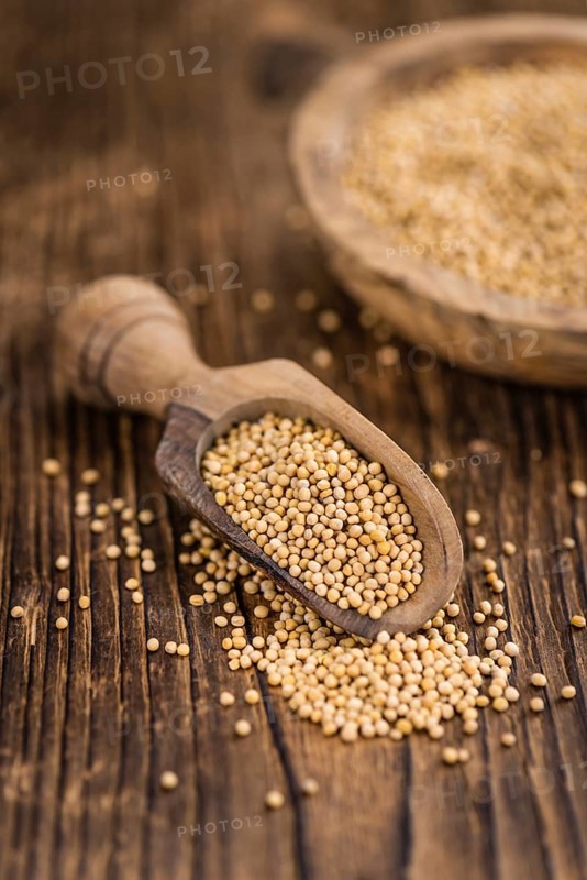 Mustard Seeds on rustic wooden background (close-up shot)