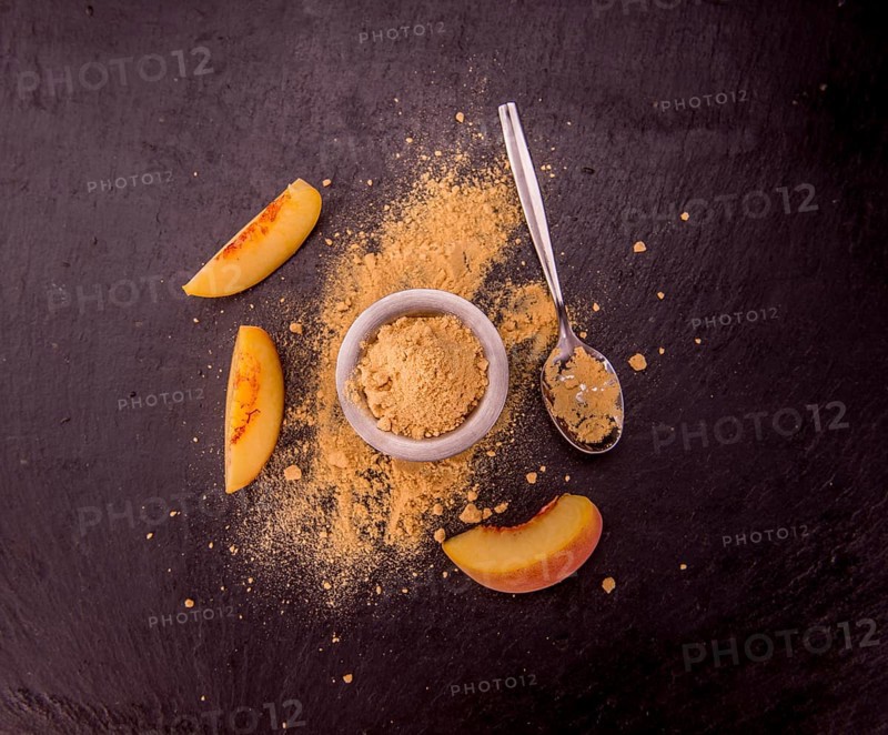 Peach powder on a vintage slate slab as detailed close-up shot, selective focus