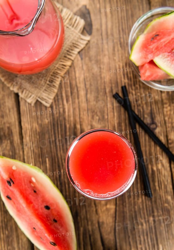 Watermelon Smoothie on rustic wooden background (close-up shot)